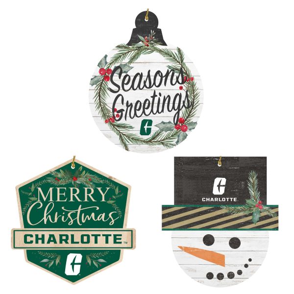 three holiday ornaments. First says "Seasons Greetings" in a wreath with Charlotte logo below. Second says Merry Christmas Charlotte with logo below. Third is a snowman head with the Charlotte logo on the cap.